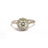 A EUROPEAN CUT DIAMOND CLUSTER RING The central diamond measuring approx. V 7mm W 7mm D 3mm and