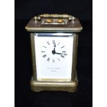 A BRASS CASED CARRIAGE CLOCK the enamel dial inscribed 'MATTHEW NORMAN LONDON', 12cm high with