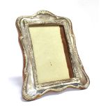 AN EARLY 20TH CENTURY SILVER FRONTED STANDING PICTURE FRAME The frame with floral patterned