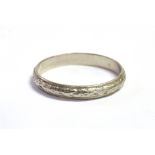 A WHITE METAL ENGRAVED PATTERN BAND RING the shank stamped PLATINUM, ring size M ½, weight 2.5grams