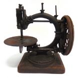 A LATE 19TH CENTURY SEWING MACHINE lacking much of its original japanned finish, unboxed.