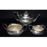 A LATE VICTORIAN MAPPIN & WEBB SILVER THREE PIECE TEA SET comprising tea pot, twin handled sugar