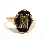 A VINTAGE 9CT GOLD BLACK ENAMELLED SIGNET RING The bezel with attached gold initial M, shank