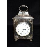 A SILVER PLATED MANTLE CLOCK the enamel dial with Roman hour markers and Arabic quarter hour, French