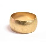 A 9CT GOLD WIDE BAND RING THE RING with faded hallmark, measuring 1.1cm wide, size S approx., weight