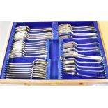 AN OAK FLATWARE THREE DRAW CHEST The chest containing part sets of EPNS and silver plated