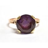 A PURPLE SAPPHIRE SOLITARE RING The faceted round cut Sapphire measuring 0.9cm in diameter, on a