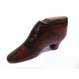 A VICTORIAN TREEN SNUFF SHOE with inlaid brass pin decoration, the heel dated '1877', 10.5cm long.
