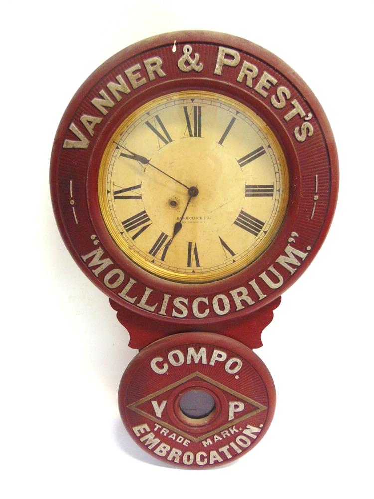 A VANNER & PREST'S 'MOLLISCORUM' EMBROCATION WALL CLOCK the cream circular dial with black Roman