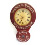 A VANNER & PREST'S 'MOLLISCORUM' EMBROCATION WALL CLOCK the cream circular dial with black Roman