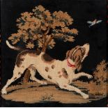 A LATE 19TH CENTURY WOOLWORK PICTURE OF A DOG looking at a bird in flight, 28.5cm x 28.5cm, framed