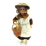 A SIMON & HALBIG FOR CUNO & OTTO DRESSEL BISQUE SOCKET HEAD DOLL with a light brown wig, sleeping