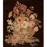 AN EARLY 19TH CENTURY WOOL & RAISED SILKWORK PICTURE depicting an arrangement of flowers in a