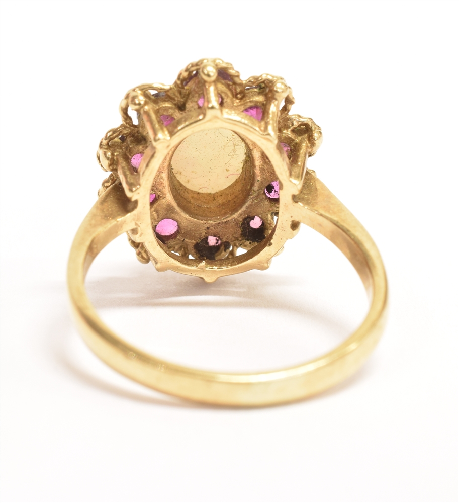 A 9CT GOLD PINFIRE OPAL AND GARNET GLASS FLOWER HEAD RING The central oval opal measuring 0.7cm x - Image 3 of 3