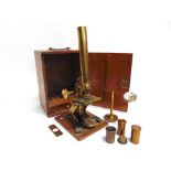 A MONOCULAR MICROSCOPE the lacquered brass frame unsigned, in a mahogany storage / travel case.