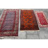 THREE RED GROUND RUGS 110cm x 186cm, 72cm x 143cm and 126cm x 216cm