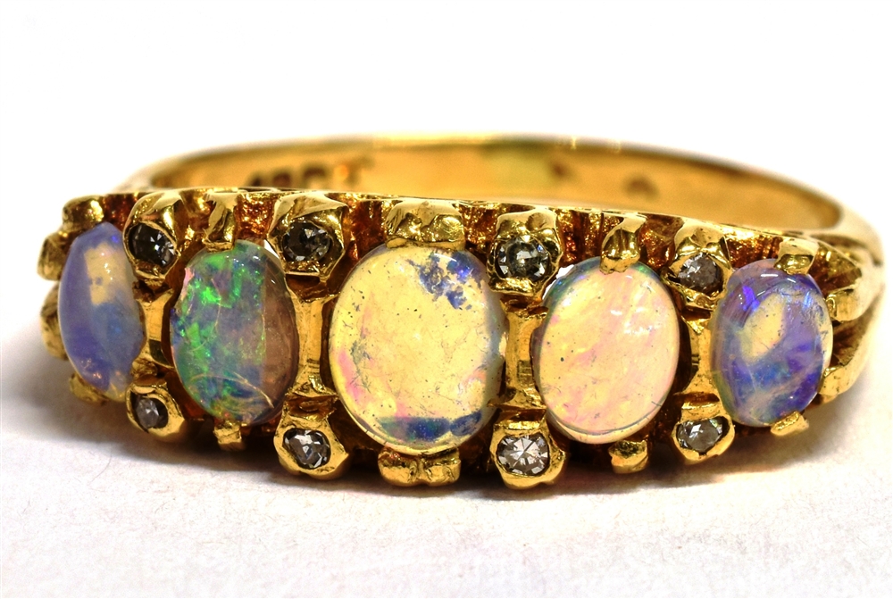 A STAMPED 18CT OPAL FIVE STONE BOAT RING The five oval graduated opals measuring approx 4mm - 5mm in