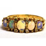 A STAMPED 18CT OPAL FIVE STONE BOAT RING The five oval graduated opals measuring approx 4mm - 5mm in