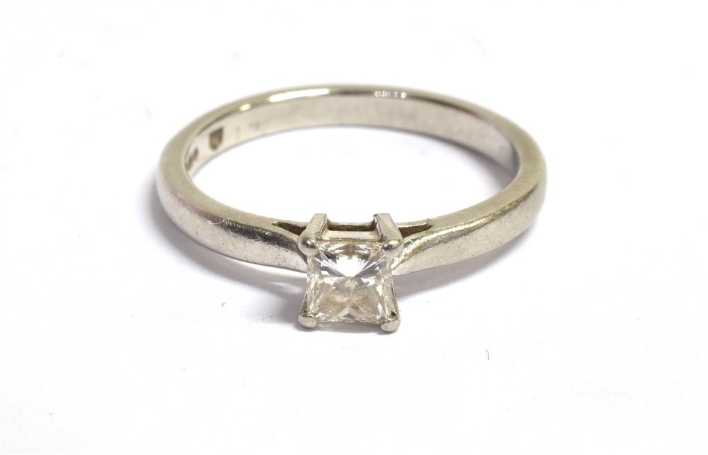 A PLATINUM PRINCESS CUT DIAMOND SOLITARIE RING The princess cut diamond measuring approx.