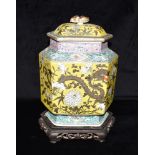 A LARGE CHINESE LIDDED VASE OF HEXAGONAL FORM decorated with a dragon and trailing foliage on a