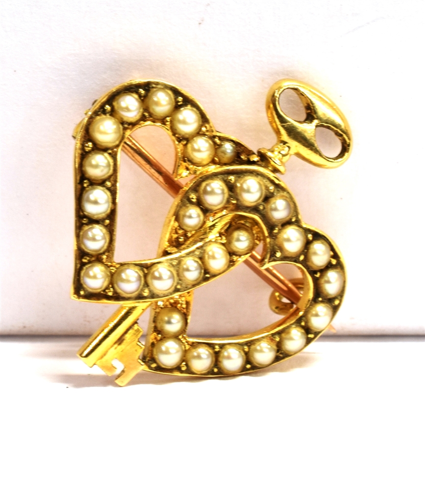 AN 18CT GOLD SEED PEARL 'KEY TO MY HEART' BROOCH The double entwined hearts set with seed pearls