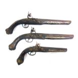 MILTARIA - THREE FLINTLOCK PISTOLS with cast metal lockplates and butt caps and brass inlaid