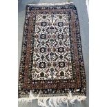 TWO RED GROUND RUGS 98cm x 180cm and 76cm x 136cm, and a blue/cream ground rug 106cm x 180cm