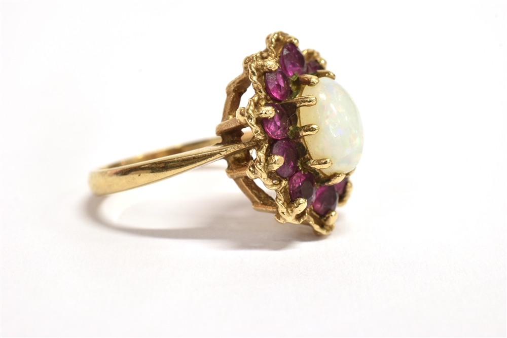 A 9CT GOLD PINFIRE OPAL AND GARNET GLASS FLOWER HEAD RING The central oval opal measuring 0.7cm x - Image 2 of 3