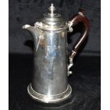 A SILVER COFFEE/HOT WATER JUG The jug with brown handle and crested lion monogram hallmarked for