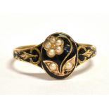 A 15CT GOLD, SEED PEARL AND BLACK ENAMEL PLAQUE RING The oval plaque in black enamel set with a seed