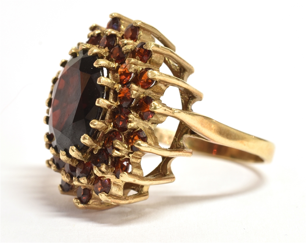 A 9CT GOLD GARNET GLASS COCKTAIL RING The cocktail ring head measuring 2.2cm x 2.2cm, the shank - Image 3 of 3