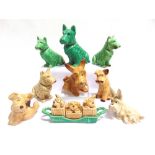 EIGHT SYLVAC DOG FIGURINES the largest 16.5cm high; together with a dog cruet set on a stand, (9).