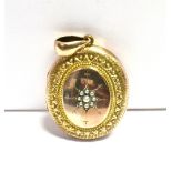 LARGE CIRCA 1900 LOCKET The locket star set to the front with a seed pearl flower, in a 9ct gold