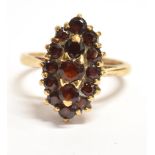 A 9CT GOLD GARNET CLUSTER RING The Navette cluster measuring 1.7cm X 1.1cm to the extremities, the
