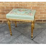 A NEEDLEWORK STOOL the gilded base with acanthus carved and fluted supports, 53cm x 40cm, 55cm