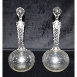 A PAIR OF VICTORIAN DECANTERS AND STOPPERS, the necks with facet cut decoration, 30cm high Condition