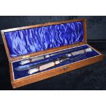 A CASED SET OF LATE VICTORIAN SILVER TOP MEAT CARVERS the handles of horn, with silver tops,