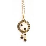 A GARNET SET PENDANT AND CHAIN The circular open work pendant set with five small garnets in