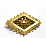 A LATE 19TH/EARLY 20TH CENTURY STAMPED 9CT BROOCH The lozenge shaped brooch fitted with a safety