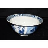 A CHINESE PORCELAIN BOWL with underlaze blue painted decoration, the exterior with figures in garden