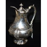 A LATE VICTORIAN SILVER COFFEE POT The pot with embossed pattern detail to the lid, belly and
