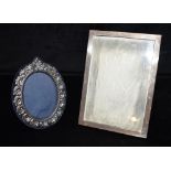 TWO SILVER FRONTED PICTURE FRAMES Plain rectangular 22 X 16 cm, fancy small oval 16 x 12.5cm