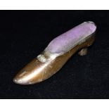 A GEORGE V SILVER PIN CUSHION The pin cushioned as a court shoe, hallmarked for Birmingham 1911,