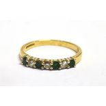 AN 18CT GOLD, DIAMOND AND EMERALD THIN BAND DRESS RING The ring set with three alternating