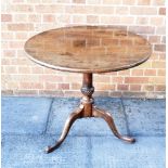 A MAHOGANY TILT TOP TRIPOD TABLE on wrythen turned stem, the one piece circular top 79cm diameter