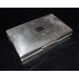 A SILVER BOX The box inset with wood, plain form, machine patterned lid with vacant cartouche,