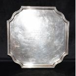 A FOOTED SILVER PRESENTATION TRAY The square tray with cut out corners and fluted boarder, on four