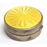 A SILVER AND GUILLOCHE ENAMEL PILL POT The circular pot with the lid in yellow guilloche enamel,