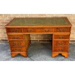 A YEW VENEERED TWIN PEDESTAL DESK with gilt tooled green leather inset top, 137cm wide 68cm deep