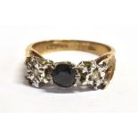 A 9CT GOLD, BLACK QUARTZ AND DIAMOND DRESS RING The circular Quartz stone flanked by a tiny diamond,